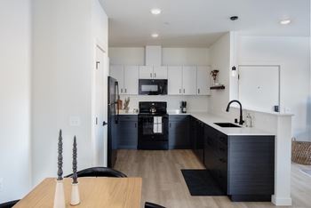 Modern kitchen w/ black appliances